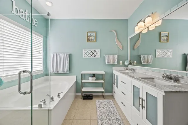 a bathroom with a tub sink and mirror