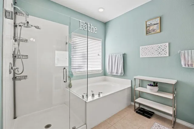 a white bath tub sitting next to a shower