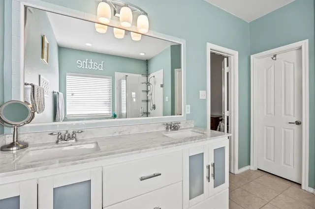 a bathroom with a sink double vanity and a mirror
