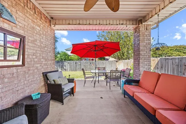 an outdoor sitting area with couch and outdoor seating