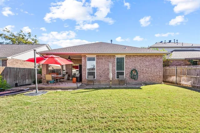 a view of a house with a yard and sitting area