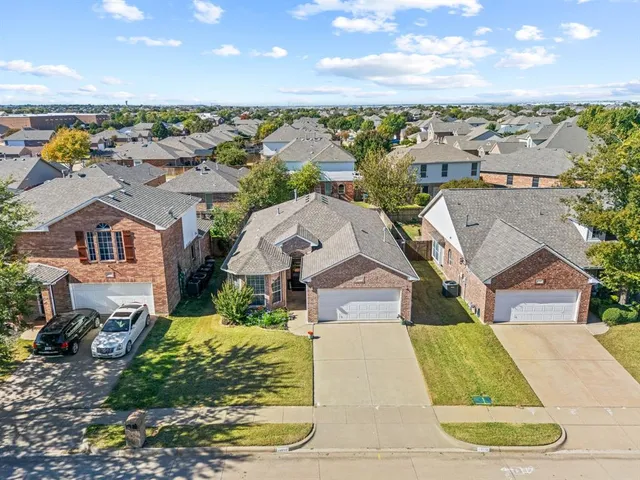 an aerial view of a house with a yard basket ball court and outdoor seating
