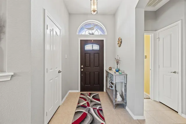 a view of a hallway to rooms and a livingroom