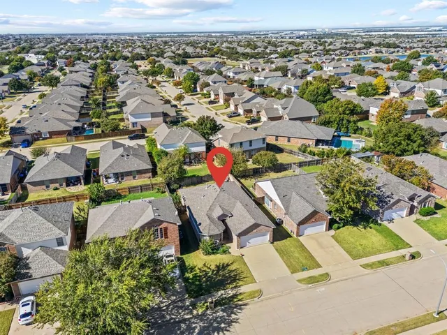 an aerial view of residential houses with outdoor space