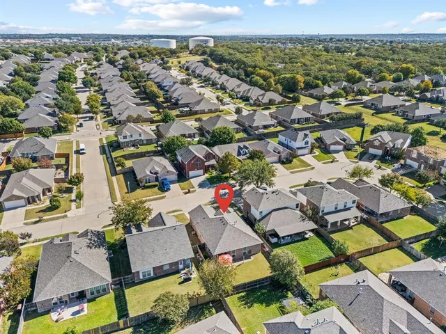 an aerial view of a residential houses with city view