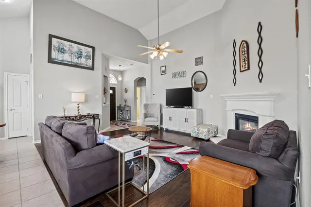 a living room with furniture fireplace and flat screen tv
