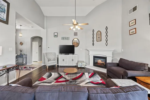 a living room with furniture fireplace and flat screen tv