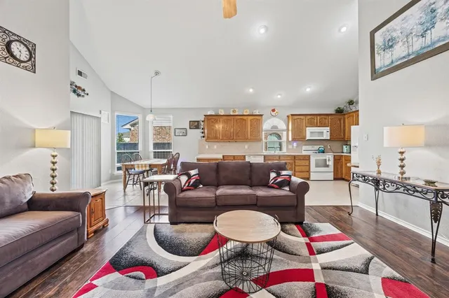 a living room with furniture and kitchen view