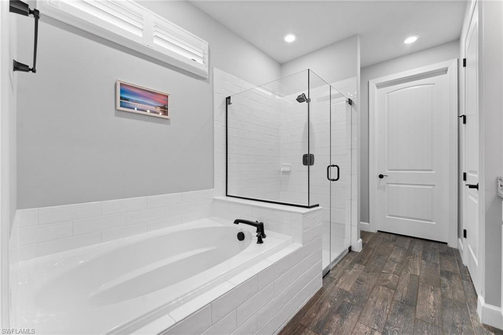 14240 Moonlit Way Estero, FL 33928 - Photo 14 of 50 a bathroom with a bathtub and a shower