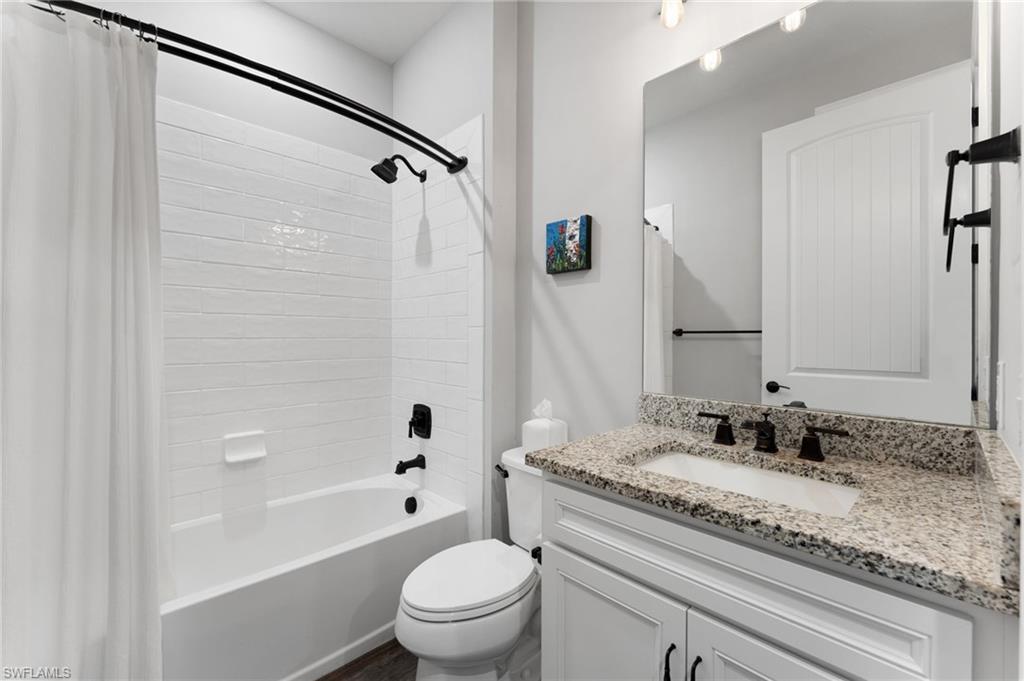 14240 Moonlit Way Estero, FL 33928 - Photo 16 of 50 a bathroom with a granite countertop sink a toilet and shower