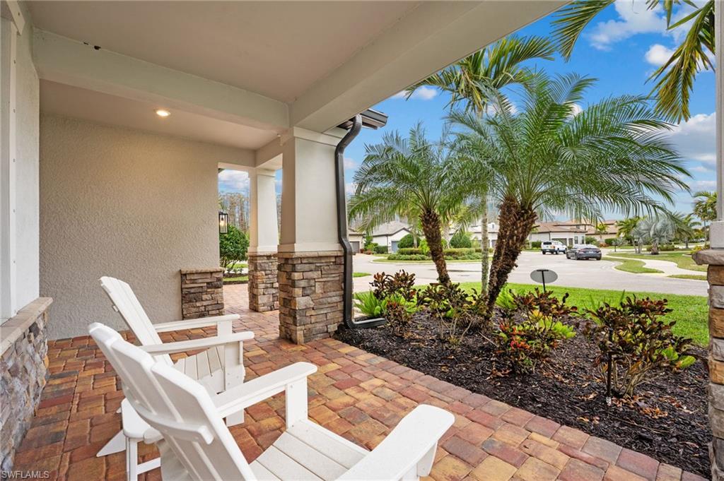 14240 Moonlit Way Estero, FL 33928 - Photo 35 of 50 a view of a patio with table and chairs and potted plants