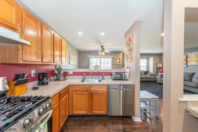 a kitchen with a sink a stove and cabinets