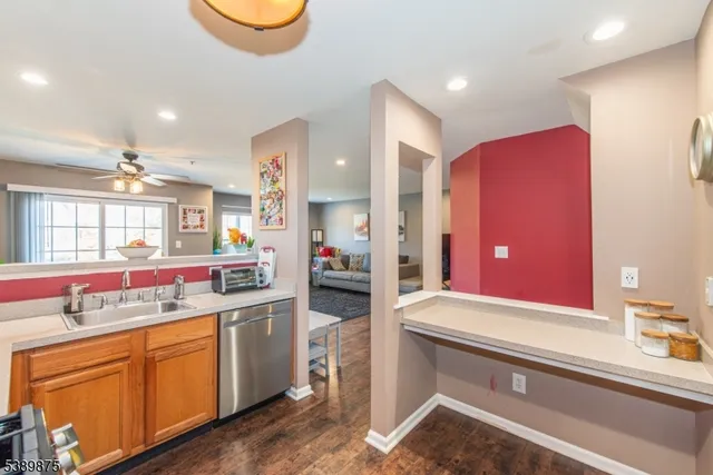 a kitchen with a sink cabinets and wooden floor