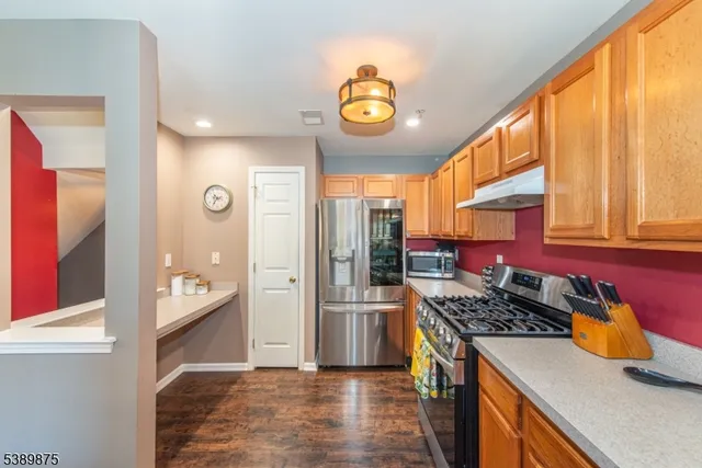 a kitchen with stainless steel appliances granite countertop a stove a refrigerator and a refrigerator