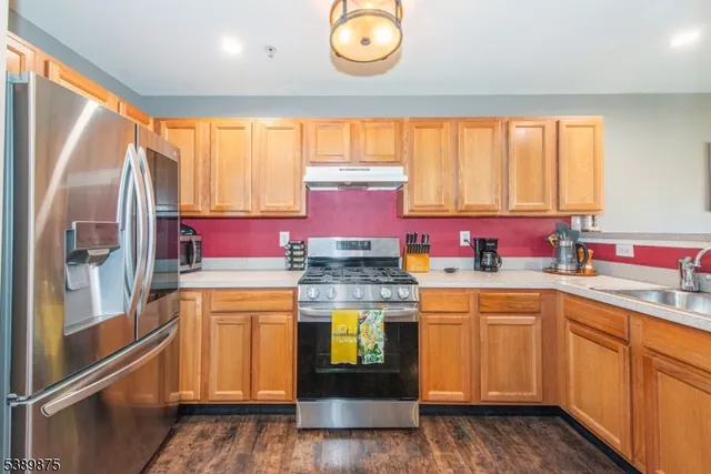 a kitchen with stainless steel appliances granite countertop a sink and cabinets