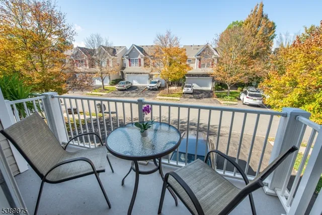 a view of a chair and tables in the balcony
