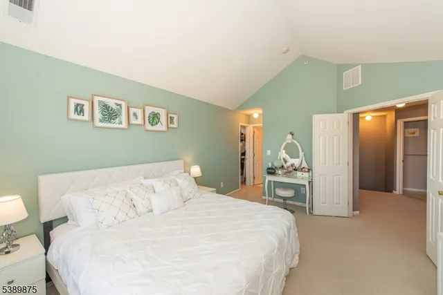 a bedroom with a large bed and dresser