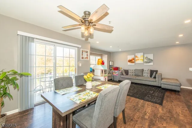 a living room with fireplace furniture and a large window