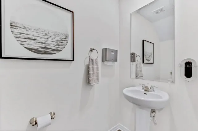 a bathroom with a sink and mirror