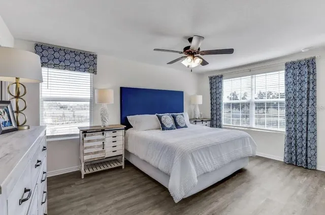 a bedroom with a large bed and a window