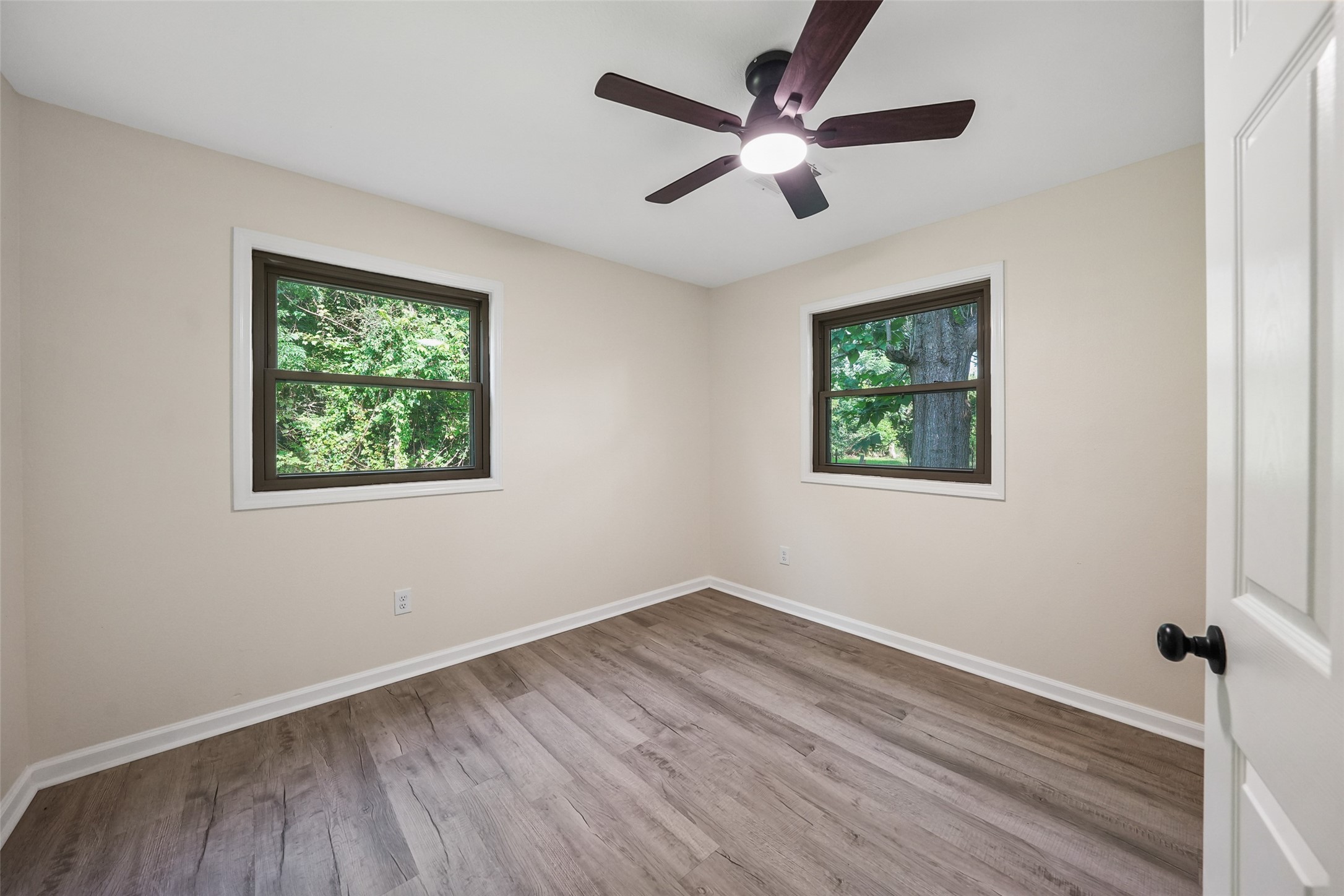 725 Lafayette Street Hempstead, TX 77445 - Photo 17 of 20 Secondary bedroom with ceiling fan, updated flooring, and two windows