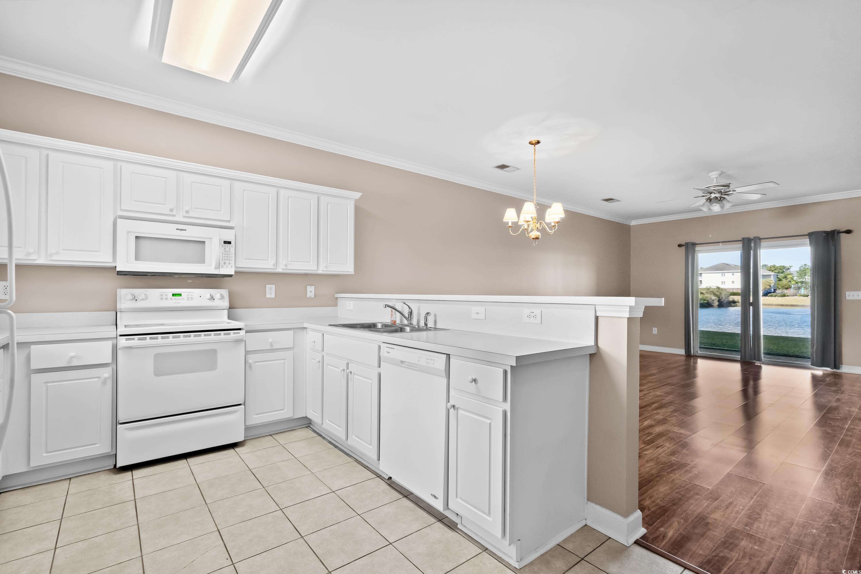 336 Kiskadee Loop, Unit B Conway, SC 29526 - Photo 15 of 40 Kitchen with kitchen peninsula, sink, pendant lighting, white cabinets, and white appliances