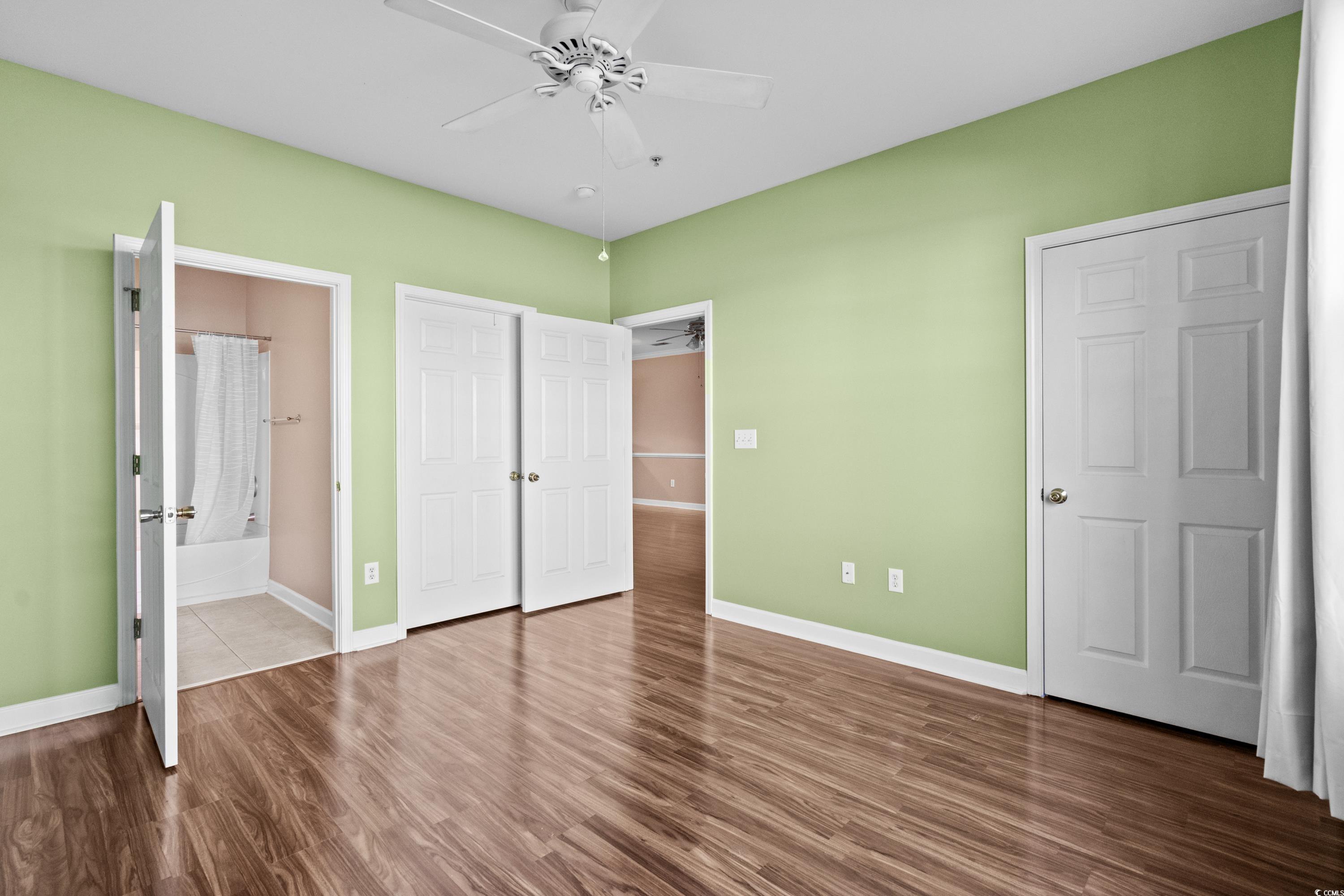 336 Kiskadee Loop, Unit B Conway, SC 29526 - Photo 24 of 40 Unfurnished bedroom featuring hardwood / wood-style floors, ensuite bathroom, and ceiling fan