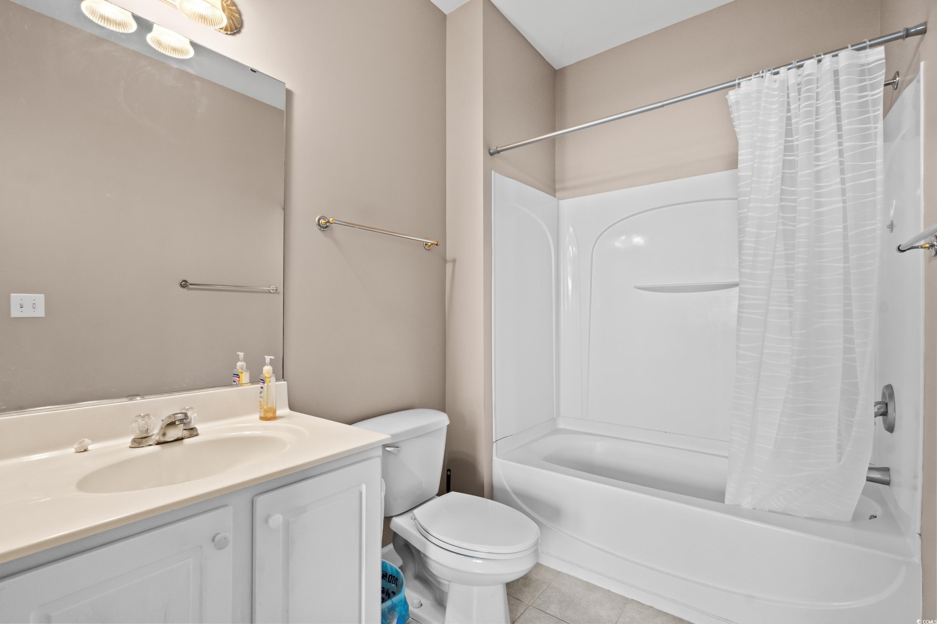 336 Kiskadee Loop, Unit B Conway, SC 29526 - Photo 25 of 40 Full bathroom featuring vanity, toilet, tile patterned floors, and shower / bath combination with curtain