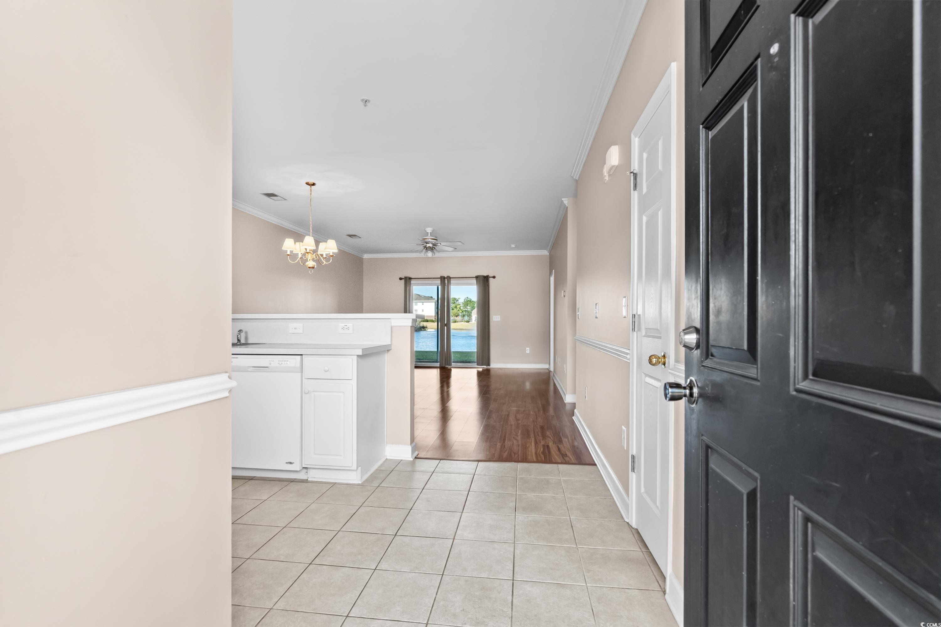 336 Kiskadee Loop, Unit B Conway, SC 29526 - Photo 5 of 40 Entrance foyer featuring crown molding, ceiling fan with notable chandelier, and light tile patterned floors