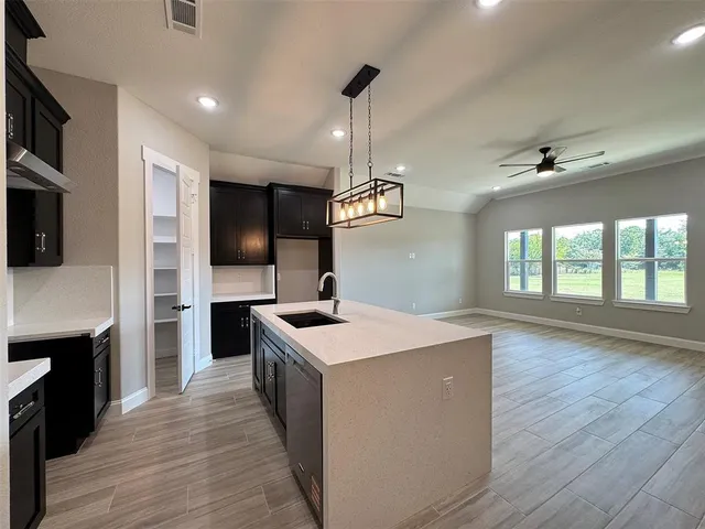 a kitchen with a stove a sink and a refrigerator