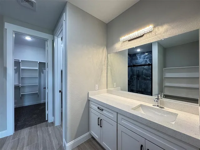 a bathroom with a double vanity sink and mirror