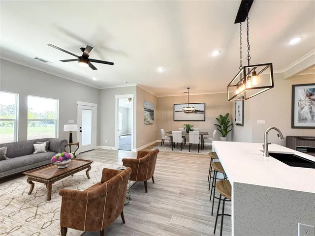 a living room with fireplace furniture and a large window