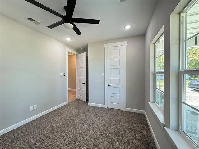 a view of an empty room and a window