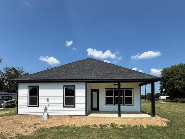 a house that has a tree in front of it