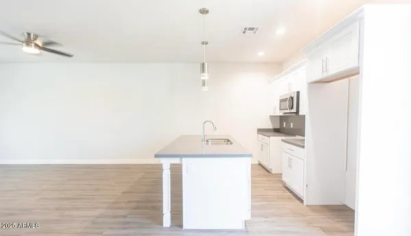 a kitchen with stainless steel appliances a refrigerator and a stove top oven