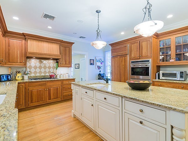 4 Cedar Street Natick, MA 01760 - Photo 3 of 21 a kitchen with stainless steel appliances granite countertop a stove a sink and a refrigerator