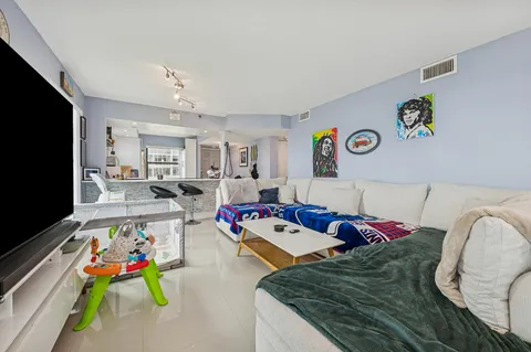 a bed room with lots of furniture and a flat screen tv