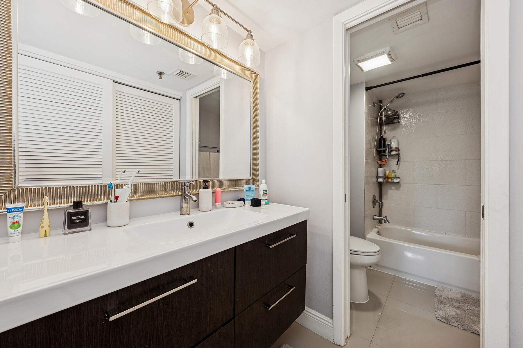 896 North Federal Highway, Unit 124 Lantana, FL 33462 - Photo 7 of 11 a bathroom with a double vanity sink toilet and shower