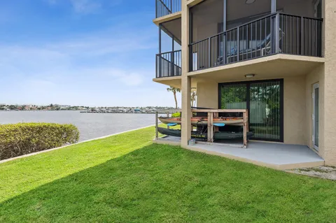 a view of a house with a yard and sitting area