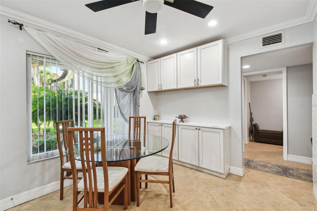 1801 East Lake Road South, Unit 3A Palm Harbor, FL 34685 - Photo 16 of 56 a view of a dining room with furniture window and outside view