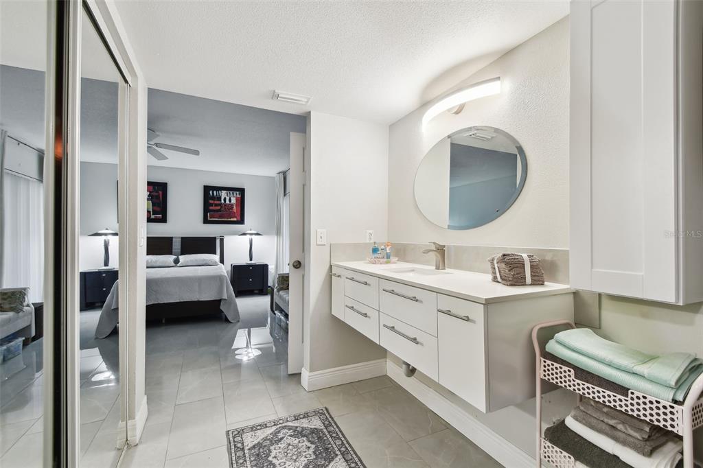 1801 East Lake Road South, Unit 3A Palm Harbor, FL 34685 - Photo 22 of 56 a bathroom with a double vanity sink mirror and bathtub