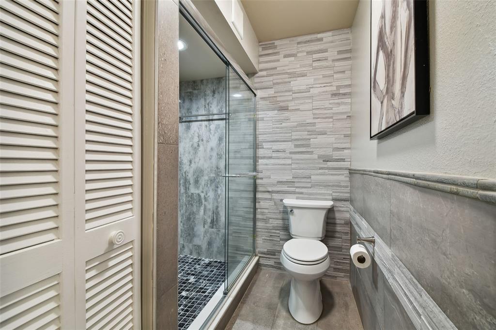 1801 East Lake Road South, Unit 3A Palm Harbor, FL 34685 - Photo 23 of 56 a bathroom with a toilet and a shower