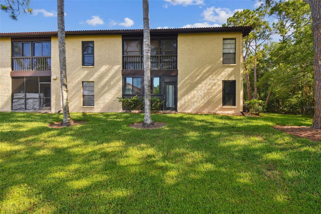 1801 East Lake Road South, Unit 3A Palm Harbor, FL 34685 - Photo 33 of 56 a view of a house with a yard
