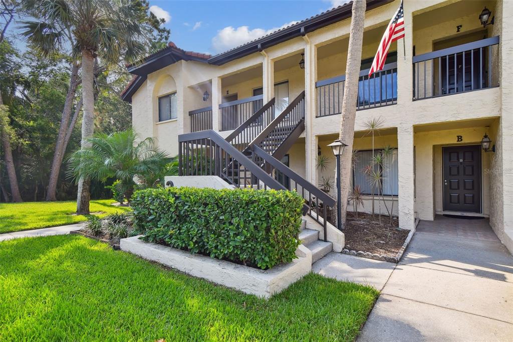 1801 East Lake Road South, Unit 3A Palm Harbor, FL 34685 - Photo 38 of 56 a front view of a house with garden