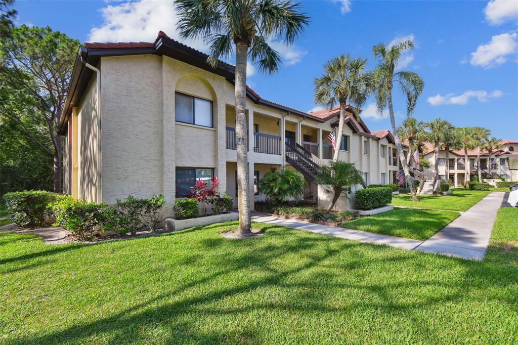 1801 East Lake Road South, Unit 3A Palm Harbor, FL 34685 - Photo 39 of 56 a view of a house with a yard and plants