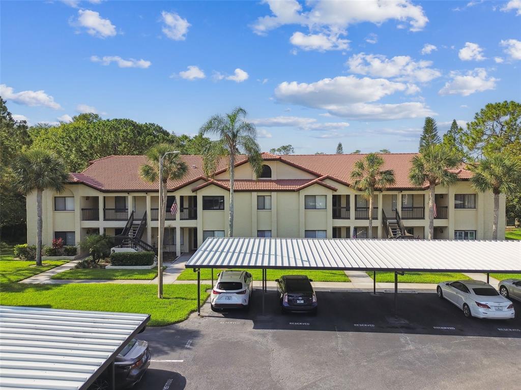 1801 East Lake Road South, Unit 3A Palm Harbor, FL 34685 - Photo 42 of 56 a front view of a house with a yard