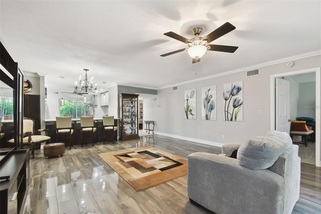 1801 East Lake Road South, Unit 3A Palm Harbor, FL 34685 - Photo 6 of 56 a living room with furniture ceiling fan and a large window