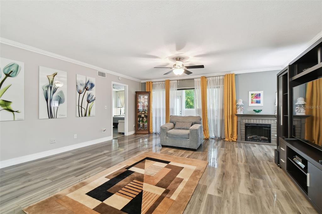 1801 East Lake Road South, Unit 3A Palm Harbor, FL 34685 - Photo 7 of 56 a living room with furniture and a flat screen tv