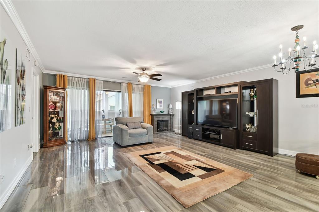 1801 East Lake Road South, Unit 3A Palm Harbor, FL 34685 - Photo 8 of 56 a living room with furniture and a flat screen tv
