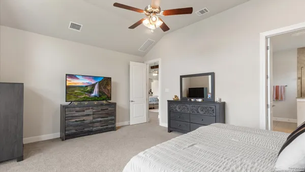 a bedroom with a bed and a dresser